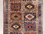 an old rug with many different colors and patterns on it