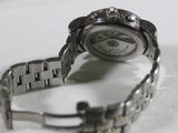 a close up of a watch on a white surface