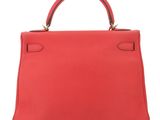 a red leather handbag on a white background