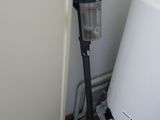 an image of a vacuum in the corner of a room