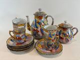 a group of tea and coffee cups and saucers on a table