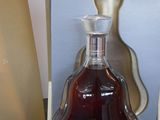 a bottle of brandy sitting on a table next to a box