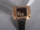 an image of a gold ring with the letter m on it