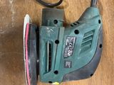 a sander on a table with a cord attached to it