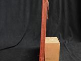 an old red book sitting on top of a wooden block
