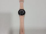 a close up of a watch on a table with a white background