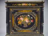 an image of a black and gold painted cabinet with flowers on it
