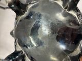 a metal object that looks like a turtle on a table
