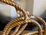 a gold rope that is connected to a metal object