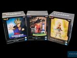 three boxes of dragon ball figures are shown on a black background