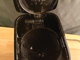an open black toaster sitting on top of a wooden table