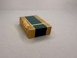 a small wooden box with a black and gold stripe on it