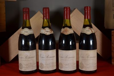 four bottles of wine are lined up in a row on a table