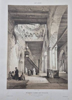 the interior of a building with people sitting on the floor