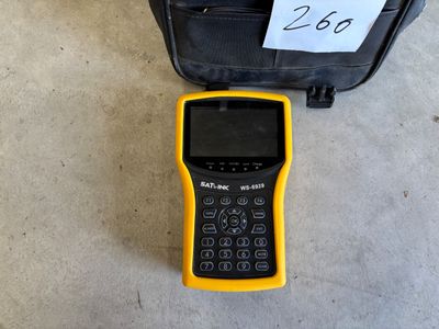 a yellow and black calculator sitting next to a black bag