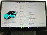 a tablet with a car on the screen in the car