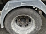 a flat tire on a flatbed truck parked in a parking lot