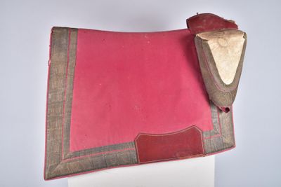 an image of a pink and brown saddle pad on top of a white table