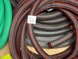 several different colored hoses are lined up on a table