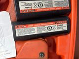 two batteries in the back of an orange case