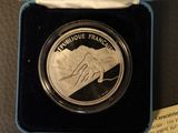 a silver coin with a picture of a horse on it