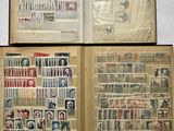 an open book with stamps on it sitting on top of a table