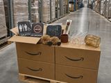a box with a sign on it sitting on a shelf in a warehouse