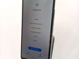 the back of a phone with a welcome screen displayed on the screen