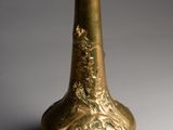 a gold vase that is sitting on a table
