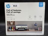 the box is open on the desk with a printer and other items