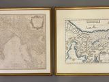 two framed maps of india and pakistan on a wall in a living room