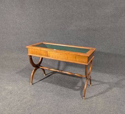 a wooden table with a glass top on a gray surface