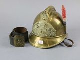 a gold fireman ' s helmet next to a brush
