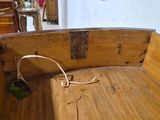 a small wooden boat with a rope on the end of it