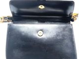 a close up of a black purse on a white background