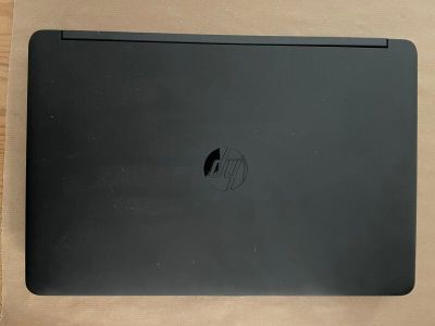 a black laptop sitting on a wooden table
