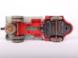 a red toy truck with wheels on a white surface