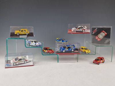 a lot of toy cars that are on display on a shelf