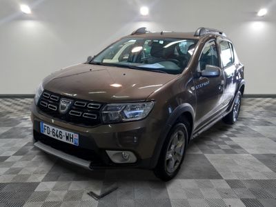 a picture of a brown dacia parked on a checkered floor
