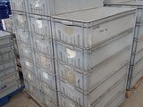 a large stack of metal containers in a warehouse