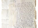 an old handwritten letter on a piece of paper on a stand