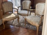 four chairs in a room with a rug on the floor