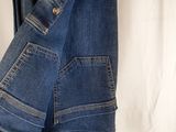 the back of a pair of jeans hanging on a hanger