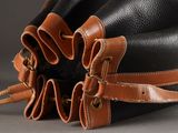 a black and brown bag with brown straps on it
