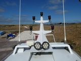 a boat with three lights on top of it in a field