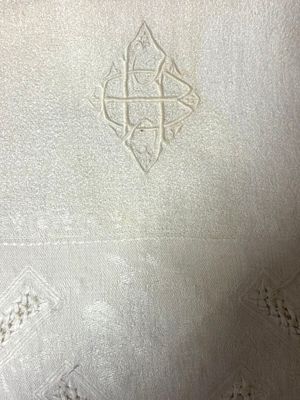 a close up of a white cloth with a cross on it