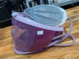 a purple microwave sitting on top of a wooden table