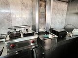 an image of a commercial kitchen with a lot of counter space