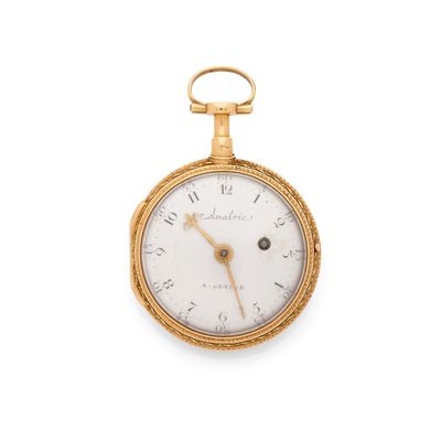 a gold pocket watch with roman numerals and roman numerals on the face