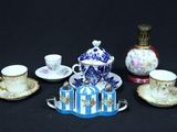 a lot of tea cups and saucers sitting on a table